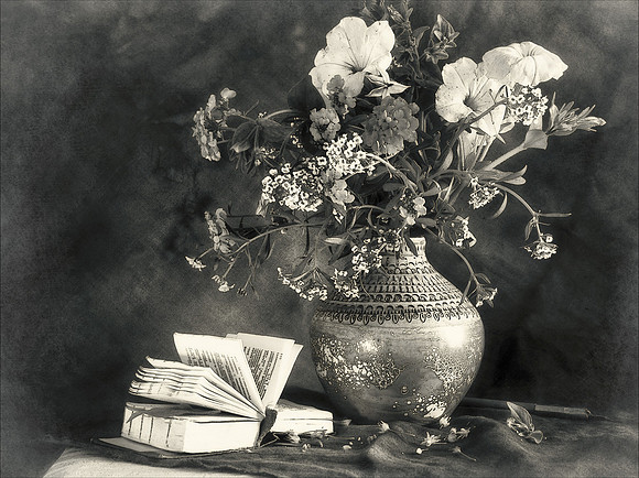 Still life with a bouquet of flowers and a book